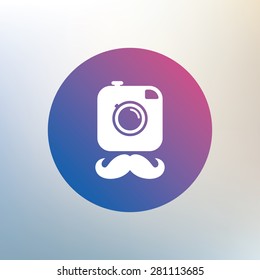 Hipster photo camera with mustache sign icon. Retro camera symbol. Icon on blurred background. Vector