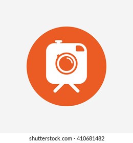 Hipster photo camera sign icon. Retro camera on tripod symbol. Orange circle button with icon. Vector