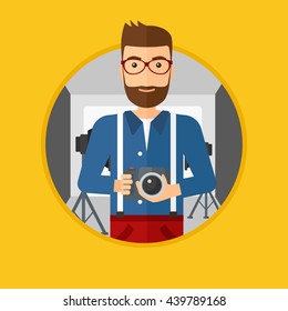 A hipster photographer with the beard holding a camera in photo studio. Photographer using professional camera in the studio. Vector flat design illustration in the circle isolated on background.