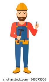 A hipster repairman in helmet with a hummer and a nail in hands vector flat design illustration isolated on white background. Vertical layout.