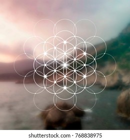 Hipster scientific illustration with flower of life - the interlocking circles ancient symbol in front of blurry photo background.