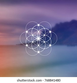 Hipster scientific illustration with flower of life - the interlocking circles ancient symbol in front of blurry photo background.