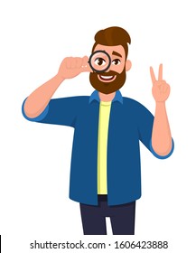 Hipster young man looking through magnifier and showing victory gesture. Successful trendy person holding magnifying glass or lens and making peace sign. Male character with loupe. Vector cartoon.