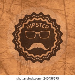hipster's badge on the brown crumbled textured paper background