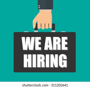 Hiring sign concept. Hand holding suitcase with `` We are hiring `` text on it. Flat style