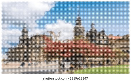 Historical cathedral architecture featuring stone towers near vibrant red autumn foliage in an urban public square setting with blue cloudy sky backdrop.