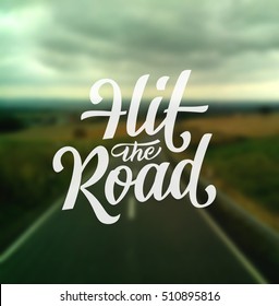 Hit the Road custom hand lettering. Vector handdrawn banner template or traveling motivation poster. Brush calligraphy piece on a defocused road going to the horizon.