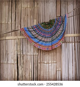Hmong hill tribe traditional skirt hanging against bamboo fence. Vector illustration