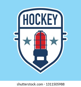 A hockey crest design with an ice hockey goal light icon in the middle.