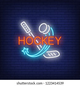 Hockey neon text with stick and flying puck. Hockey advertisement design. Night bright neon sign, colorful billboard, light banner. Vector illustration in neon style.