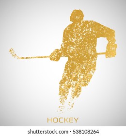 Hockey player from the gold particles. Silhouette of a hockey player consists of small abstract Golden forms. Vector image