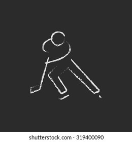 Hockey player hand drawn in chalk on a blackboard vector white icon isolated on a black background.