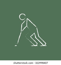 Hockey player hand drawn in chalk on a blackboard vector white icon isolated on a green background.