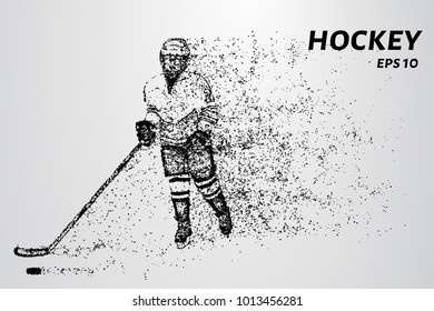 Hockey player slides on the ice with the puck. Hockey consists of particles