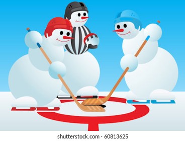 Hockey referee drops puck to draw the two hockey players.