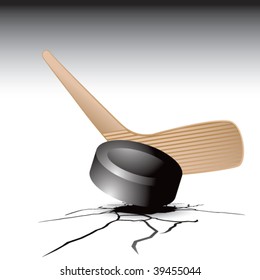 hockey stick and puck on cracked ground