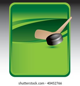 hockey stick and puck on green background