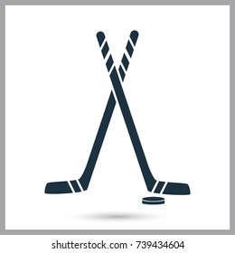 Hockey stick and puck simple icon