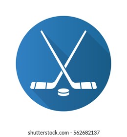 Hockey sticks and puck. Flat design long shadow icon. Hockey game equipment. Vector silhouette symbol