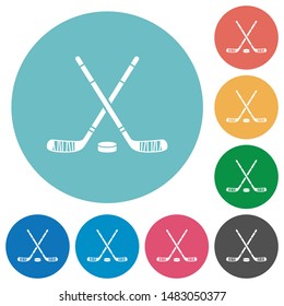 Hockey sticks with puck flat white icons on round color backgrounds