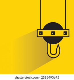 hoist crane hook icon with shadow on yellow background