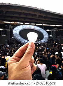 holding guitar pick in the hand. 