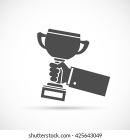 Holding trophy cup in hand