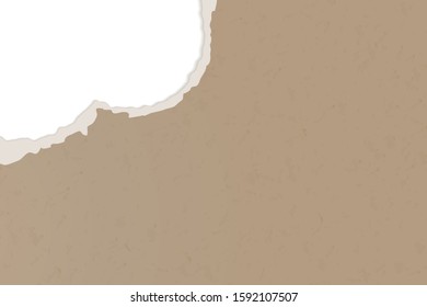 A hole in the ripped recycled paper background. Cardboard or paperboard kraft paper frame.