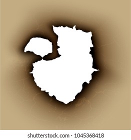 Hole torn in ripped paper with burnt and flame