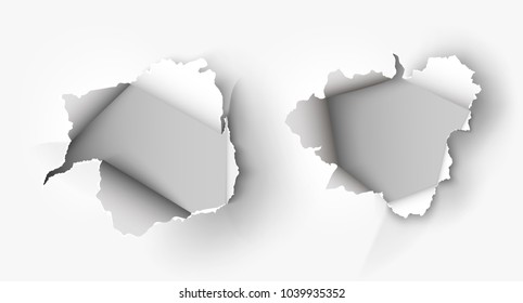 Hole torn in ripped paper on white background