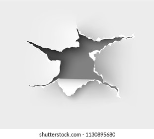 Hole torn in ripped paper on white background