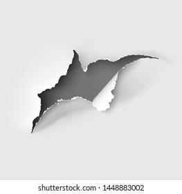 Hole torn in ripped paper on white background