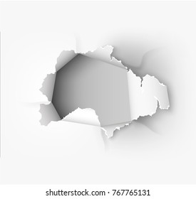 Hole torn in ripped paper on white background