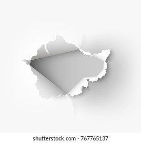 Hole torn in ripped paper on white background