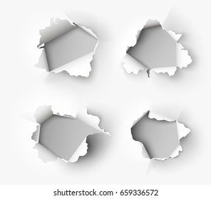 Holes torn in paper on white background