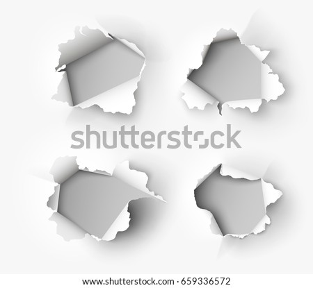 Holes torn in paper on white background