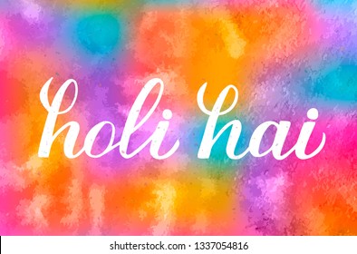 Holi hai calligraphy hand  lettering  on colorful watercolor background. Indian Traditional festival of colors. Hindu spring celebration poster. Vector template for party invitations, banners, flyers.