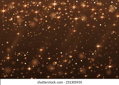 Holiday abstract Christmas background with snowflakes and shiny stars in golden color. New year lights, starry sky 