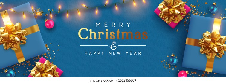 Holiday banner Merry Christmas and Happy New Year. Xmas design with realistic festive objects, blue gift box, lilac ball, light lamps garland, glitter gold confetti. Horizontal poster, flat top view