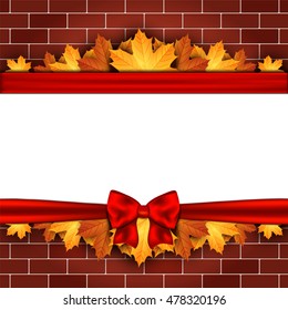 Holiday banner on brick wall with autumn leaves and red bow. Autumn background. Christmas card.