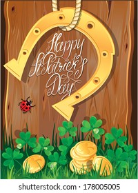 Holiday card with calligraphic words Happy St. Patrick`s Day. Shamrock, horseshoe, ladybug and golden coins on wooden background