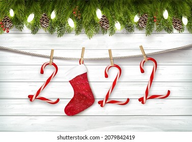 Holiday Christmas background with branch of tree and christmas candy cane, a red socket on the rope. Vector