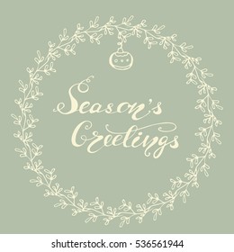 Holiday circle card design with handwritten lettering "Season's greetings". Vector illustration   with floral wreath and ornament.