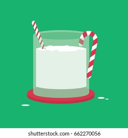 Holiday drink with straw and candy cane on green background