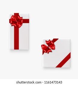 Holiday gift white box set with red satin bow. Top view realistic 3d vector object. Satin silk ribbon mockup template. Birthday, Christmas, Valentines Day sale. Festive package decoration.