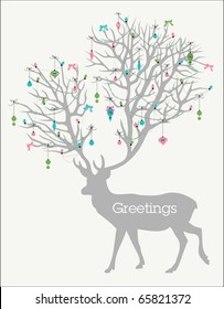 Holiday greetings! Silhouette of deer with huge antlers decorated with lights and ornaments