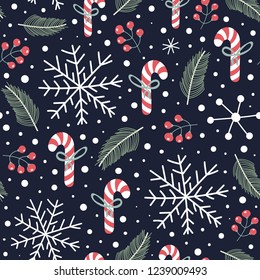 Holiday seamless pattern with Christmas candies, snoflakes, fir branches and berries. Winter cute background. Vector illustration