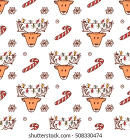 Holiday seamless pattern with Christmas reindeer and Christmas candy sticks. Hand drawn doodle vector illustration