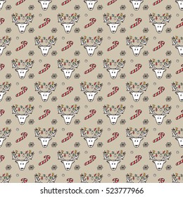 Holiday seamless pattern with Christmas reindeer and Christmas candy sticks. Hand drawn doodle vector illustration.