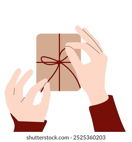 Holiday wrapping. Close up of hands tying a bow on gift with Christmas background. Gift-wrapping services or products